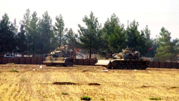 Turkish army tanks are stationed near the border with Syria in Karkamis Turkey on Wednesday