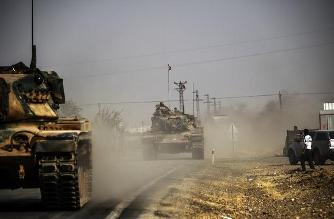 Turkish army tanks drive to the Syrian border town of Jarabulus after launching a ground operation for the first time in Syria