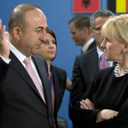 Turkish Foreign Minister Mevlut Cavusoglu left speaks with Swedish Foreign Minister Margot Wallstrom during a meeting of the North Atlantic Council at NATO headquarters in Brussels. Turkey has summo