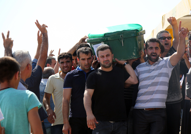 People carry a victim's coffin as they attend funeral services for dozens of people killed in last night's bomb attack targeting an outdoor wedding party