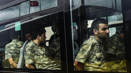 Detained Turkish soldiers who allegedly took part in a military coup arrive in a bus at the courthouse in Istanbul