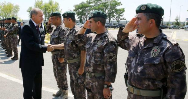 Turkey's President Recep Tayyip Erdogan left shakes hands with officers of the special police forces at their headquarters in Ankara Turkey on Friday