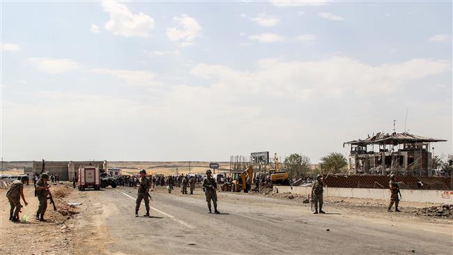 Turkish soldiers are seen at the site of a car bomb explosion