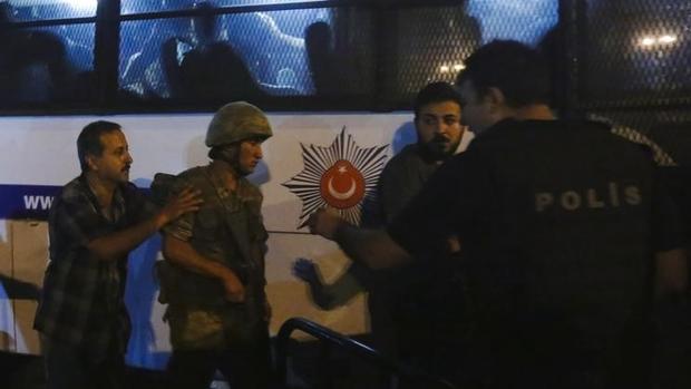 Turkish soldiers surrender to policemen during an attempted coup in Istanbul's Taksim Square Turkey on July 16. REUTERS  Murad Sezer