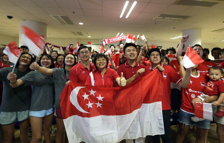 Singaporean watch a live broadcast on television of Singaporean swimmer Joseph Schooling competing at the Rio olympic in Singapore