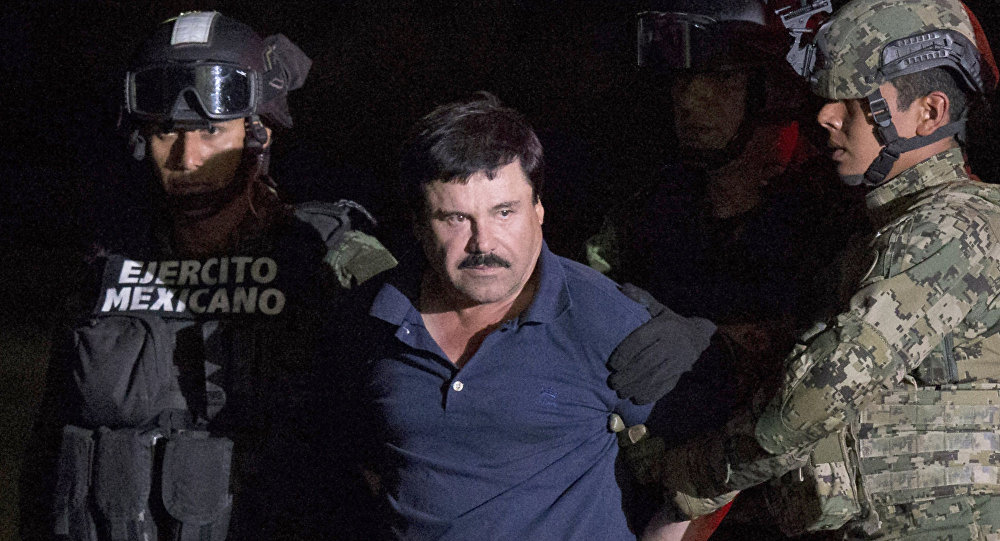 ALTERNATIVE CROP OF RLB111. Mexican drug lord Joaquin El Chapo Guzman is escorted by army soldiers to a waiting helicopter at a federal hangar in Mexico City Friday Jan. 8 2016