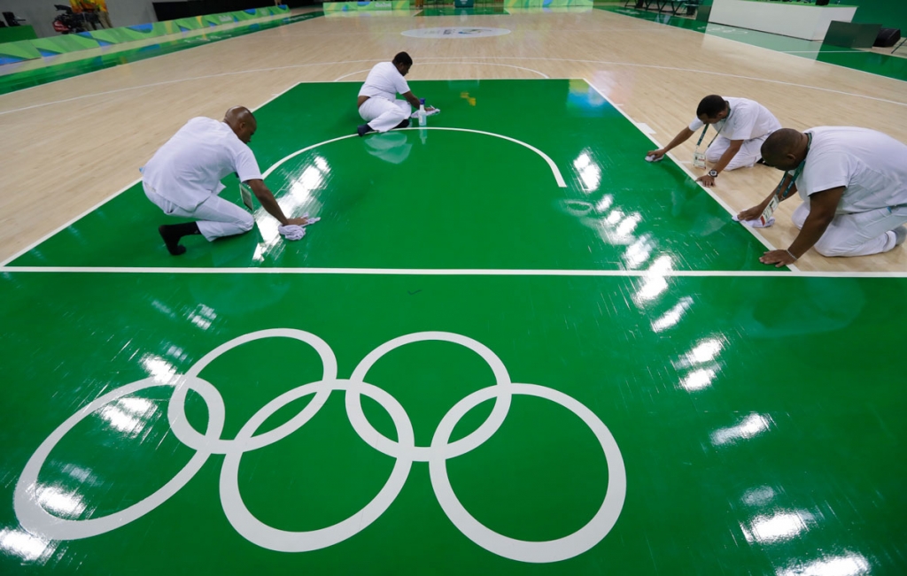 Work crews clean the basketball floor during an off day for women's basketball at the Youth Center at the 2016 Summer Olympics in Rio de Janeiro Brazil Friday Aug. 5 2016. The women's competition begins on Saturday