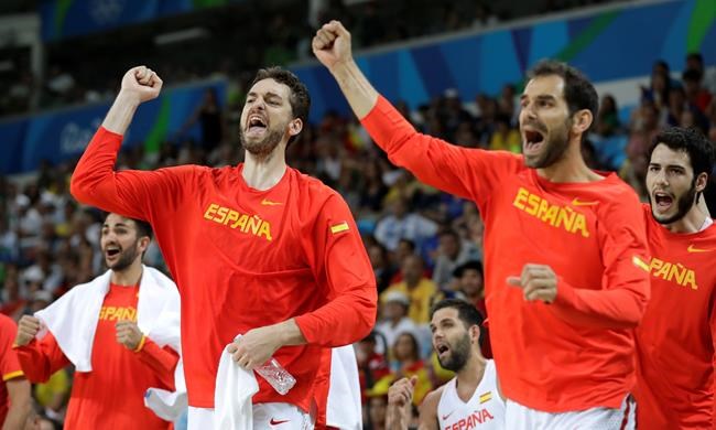 Spain's Pau Gasol left and Jose Calderon right celebrate on the bench during a quarterfinal round basketball game against France at the 2016 Summer Olympics in Rio de Janeiro Brazil Wednesday Aug. 17 2016