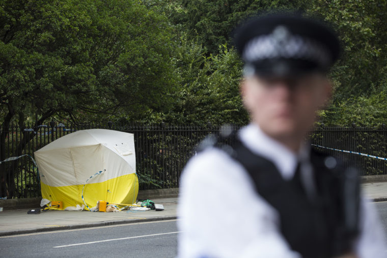 A police officer guards the spot in Russell Square central London where an American woman was killed during a knife attack which left five others injured