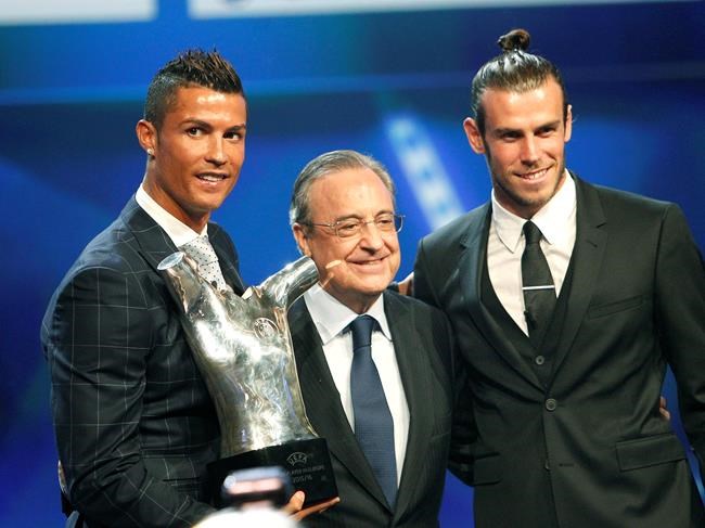 Real Madrid's forward Cristiano Ronaldo of Portugal left holds his'best player of the year trophy as he poses with Real Madrid's forward Gareth Bale right who was nominated for the same award and Real Madrid's president Florentino Pere