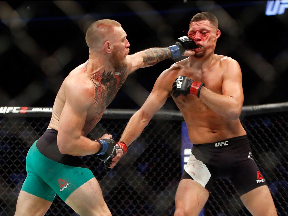 Conor Mc Gregor hits Nate Diaz with a left during their welterweight rematch at the UFC 202 event at T Mobile Arena