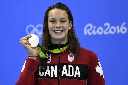 Canada's Penny Oleksiak celebrates on the podium after she won silver in the Women's 100m Butterfly Final during the swimming event at the Rio 2016 Olympic Games at the Olympic Aquatics Stadium in Rio de Janeiro