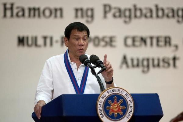 Philippine President Rodrigo Duterte gestures while delivering a speech during the 115th Police Service Anniversary at the Philippine National Police headquarters in Quezon city metro Manila Philippines