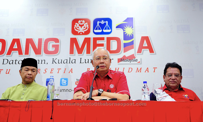 Najib flanked by party vice-president Datuk Seri Dr Zahid Hamidi and secretary-general Datuk Seri Tengku Adnan Tengku Mansor at press conference after chairing a meeting of the Umno supreme council. — Bernama