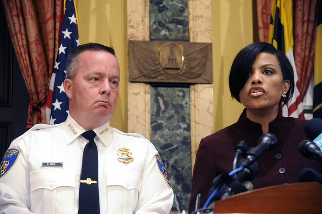 Police Commissioner Kevin Davis left listens as Baltimore Mayor Stephanie Rawlings Blake speaks during a news conference at City Hall in response to a Justice Department report Wednesday Aug. 10 2016 in Baltimore. The Justice Department and Baltimore