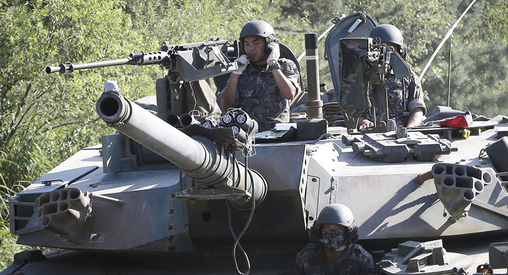 South Korean army soldiers ride a K-1 tank during the annual exercise in Paju South Korea near the border with North Korea