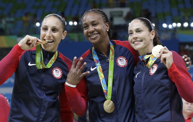 United States Diana Taurasi left Tamika Catchings center and Sue Bird right celebrate with their gold medals after their win in a women's basketball