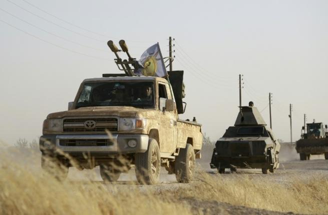 US-backed Kurdish and Arab fighters advance into the Islamic State group bastion of Manbij in northern Syria in June 2016