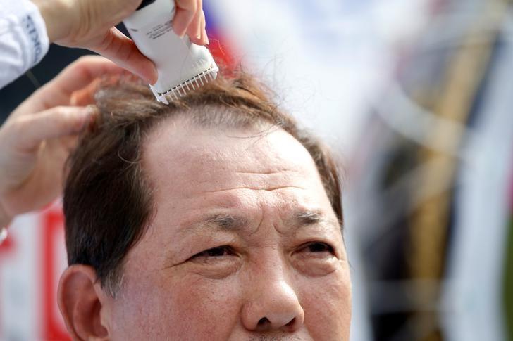 Seoungju County Governor Kim Hang-gon gets his head shaved during a protest against the government's decision on deploying a U.S. THAAD anti-missile defense unit in Seongju in Seoul South Korea