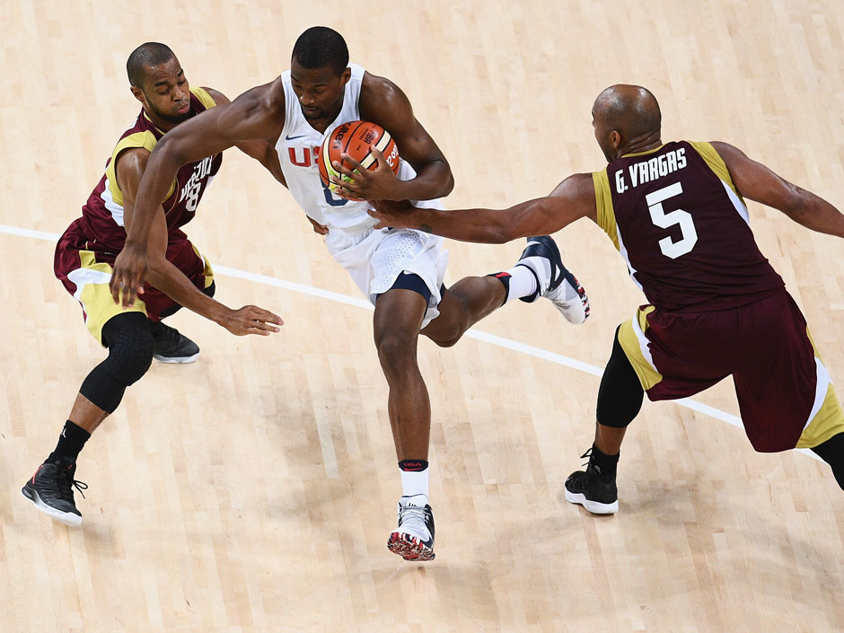 Harrison Barnes of United States drives in between David Cubillan and Gregory Vargas of Venezuela