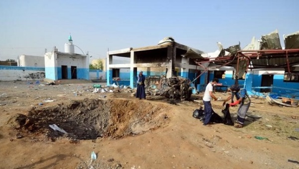 Workers collect human remains at the yard of a hospital operated by Medecins Sans Frontieres after it was hit by a Saudi-led coalition air strike in the Abs district of Hajja province Yemen