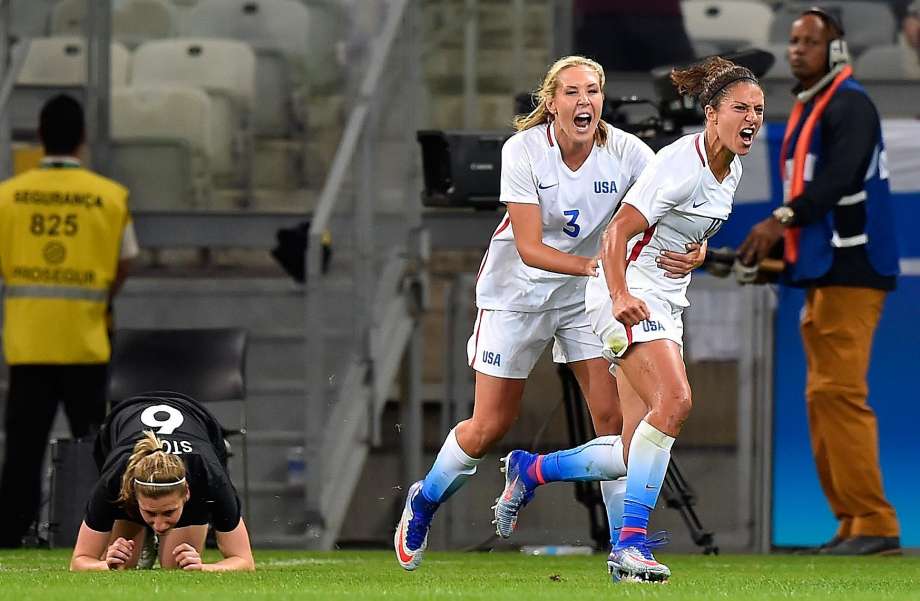 Carli Lloyd and Allie Long celebrate Lloyd’s first half goal that prved to be the game-winner against New Zealand in a Group G match at Belo Horizonte Brazil