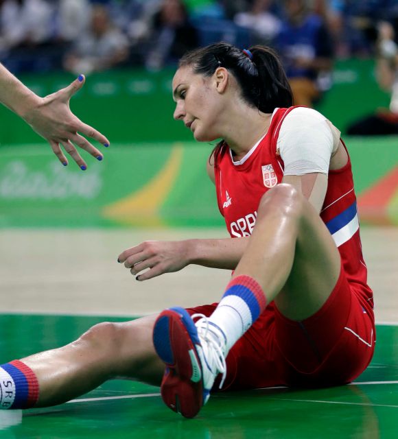 Serbia's Sonja Petrovic is helps up after she