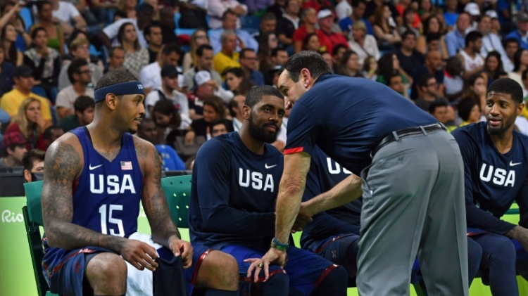 USA's head coach Mike Krzyzewski talks with forward Carmelo Anthony, guards Kyrie Irving and Paul George on the bench