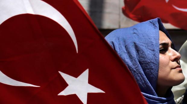 A supporter of Turkish President Tayyip Erdogan takes part in a pro-government demonstration in Sarachane park in Istanbul Turkey