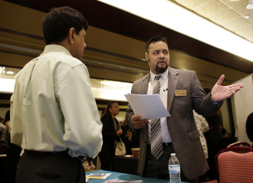 Ronnie Teheran with Service Corporation International right talks with a job applicant at a job fair in Miami Lakes Fla. Payroll processor ADP reports employment figures for July on We