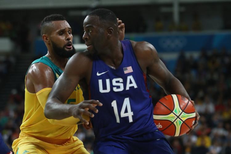 USA's Draymond Green of the Warriors works on Australia's Patty Mills of the Spurs