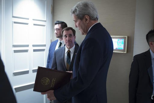 Secretary of State John Kerry speaks to senior adviser John Kirby before a news conference in Vienna. The State Department says a 0 million cash payment to Iran was contingent on the release of American priso