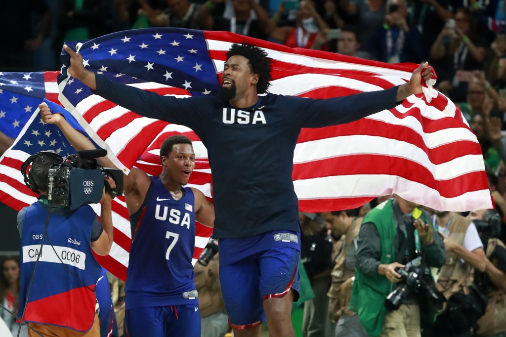 OLY BKO MEN 12-118 De Andre Jordan center and Kyle Lowry of the U.S. celebrate with American flags after the men's basketball gold medal game against Serbia Sunday at in Rio de Janeiro. The U.S. team won 96-66 to take the gold medal