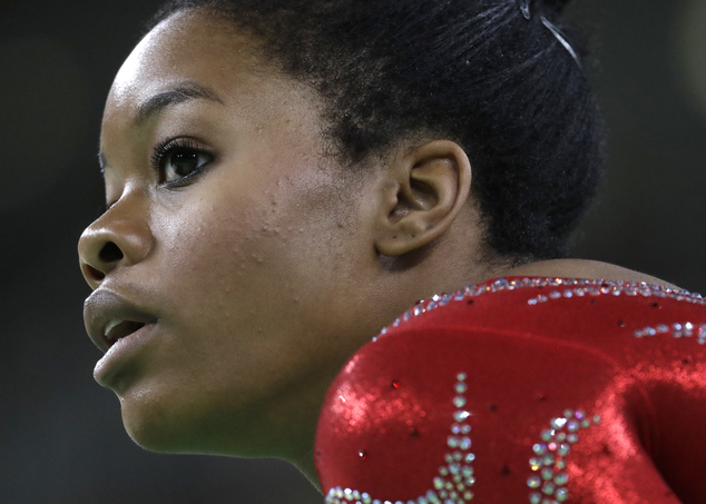 United States Gabrielle Douglas rests after her floor routine during the artistic gymnastics women's qualification at the 2016 Summer Olympics in Rio de Jan