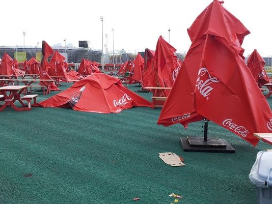 Umbrellas in the fan gathering area at the Olympic Park blew over in high winds Sunday