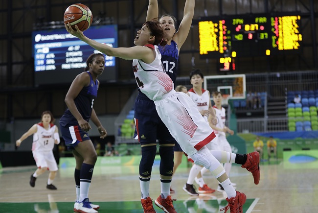 Japan guard Sanae Motokawa makes a layup defended by France guard Gaelle Skrela during the second half of a women's basketball game at the Youth Center at the 2016 Summer Olympics in Rio de Janeiro Brazil Saturday Aug. 13 2016. (AP