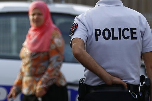 Police officers conduct a search as they investigate an attack on a church that left a priest dead in Saint-Etienne-du-Rouvray Normandy France Tuesday