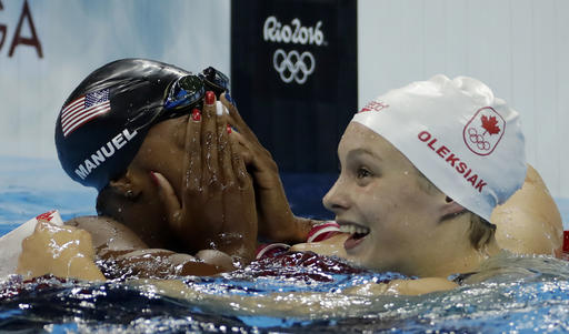 United States Simone Manuel left and Canada's Penny Oleksiak celebrate winning joint gold and setting a new Olympic record