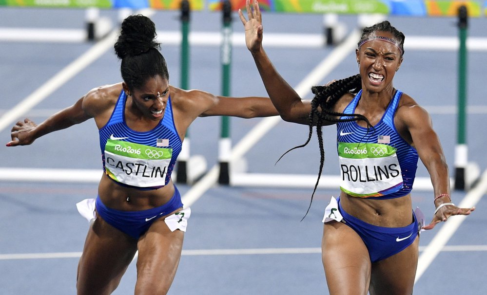 Brianna Rollins of the United States right wins the gold medal in the women's 100-meter hurdles Wednesday night. Kristi Castlin of the U.S. left was third as the Americans swept the event