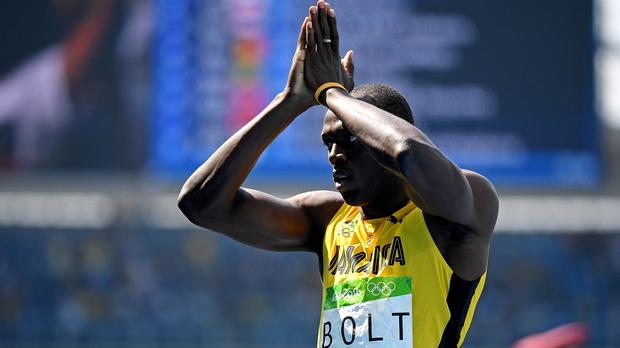 Usain Bolt acknowledges the crowd after winning his qualifying heat in the 200-meter.
                    USATSI