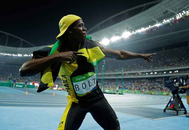 Usain Bolt gave his signature lightning bolt pose after winning the 100-meter dash on Sunday night. Matt Slocum  AP Click