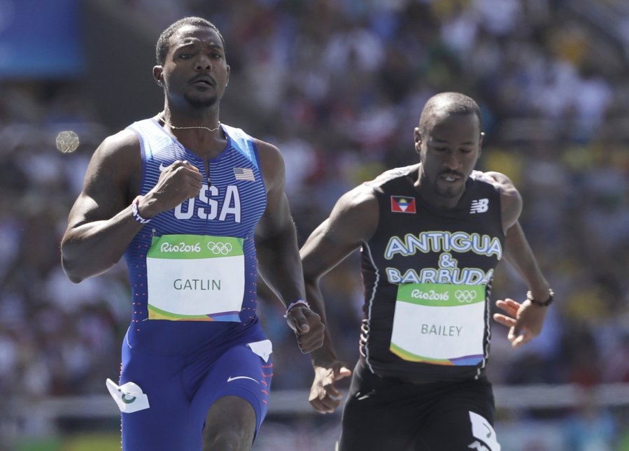 United States&apos Justin Gatlin left and Antigua & Barbuda's Daniel Bailey compete in a men's 100-meter heat during the athletics competitions of the 2016 Summer Olympics at the Olympic stadium in Rio de Janeiro Brazil Saturday Aug. 13 2