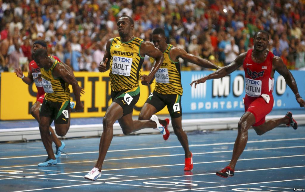 Usain Bolt of Jamaica crosses the finish line next to American Justin Gatlin winning the 100 meter race in a competition before Rio