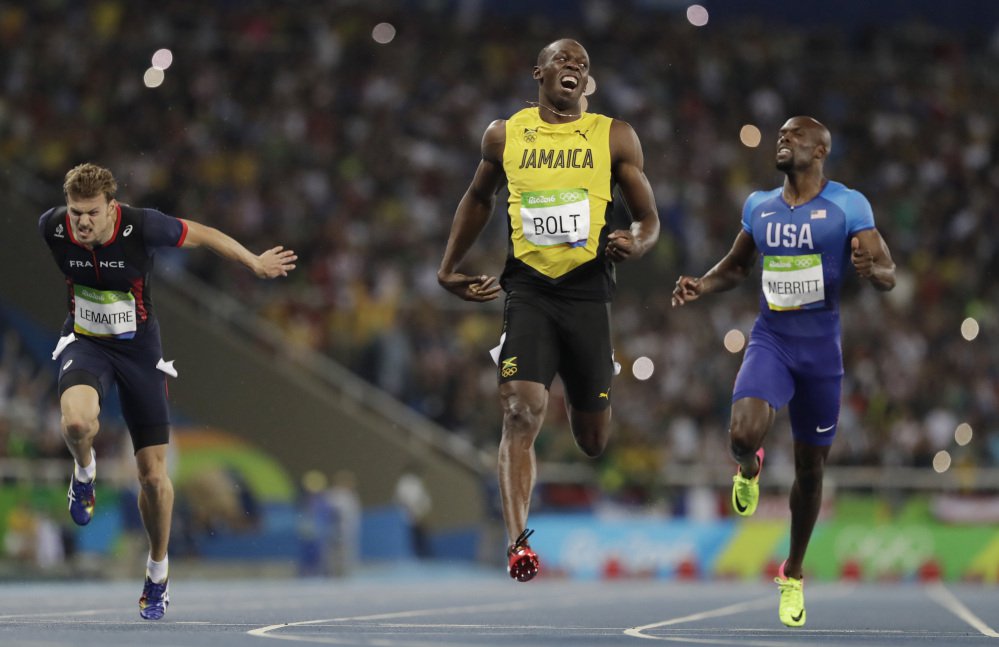 Usain Bolt of Jamaica center celebrates after crossing the line to win the gold medal in the men's 200-meter final Thursday in Rio de Janeiro Brazil