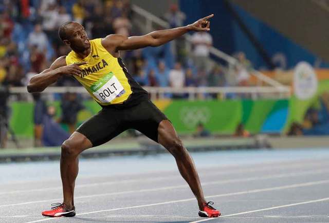 Usain Bolt showed off his signature pose after winning the 200-meter final on Thursday. David J. Phillip  AP Click