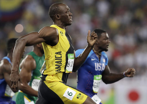 Jamaica's Usain Bolt leads ahead of United States Justin Gatlin in the men's 100-meter final during the athletics competitions of the 2016 Summer Olympics at the Olympic stadium in Rio de Janeiro Brazil Sunday Aug. 14 2016. (AP