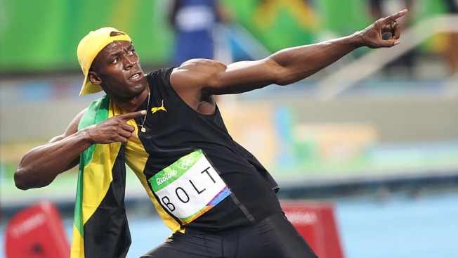 Usain Bolt strikes his'lightning bolt pose after winning gold in the 100-meter dash finals Sunday.   Getty Images