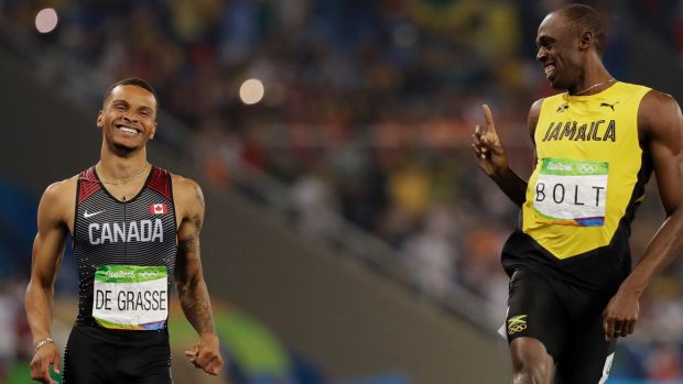 Usain Bolt wags his finger at Andre de Grasse after the men's 200-metre semifinal