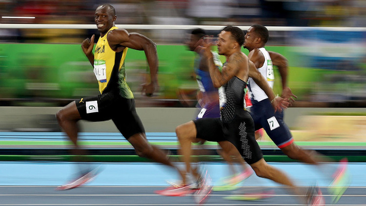 Usain Bolt Smiles For The Camera While Winning the Olympic Gold