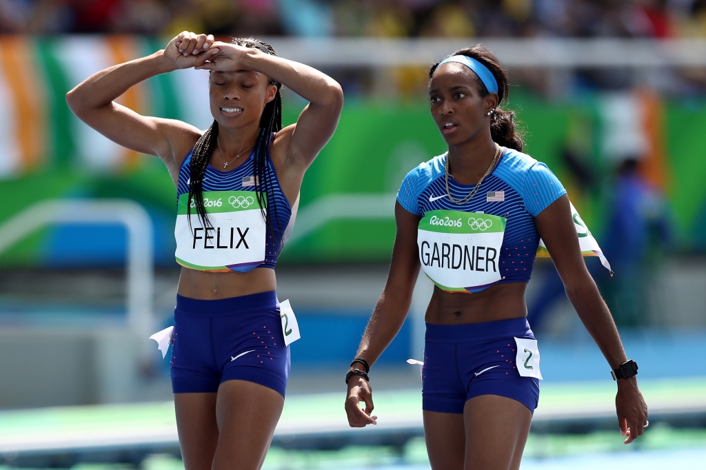 Allyson Felix of the United States and English Gardner of the United States react during round one of the Women's 4 x 100m Relay on Day 13 of the Rio 2016 Olympic Games at the Olympic Stadium